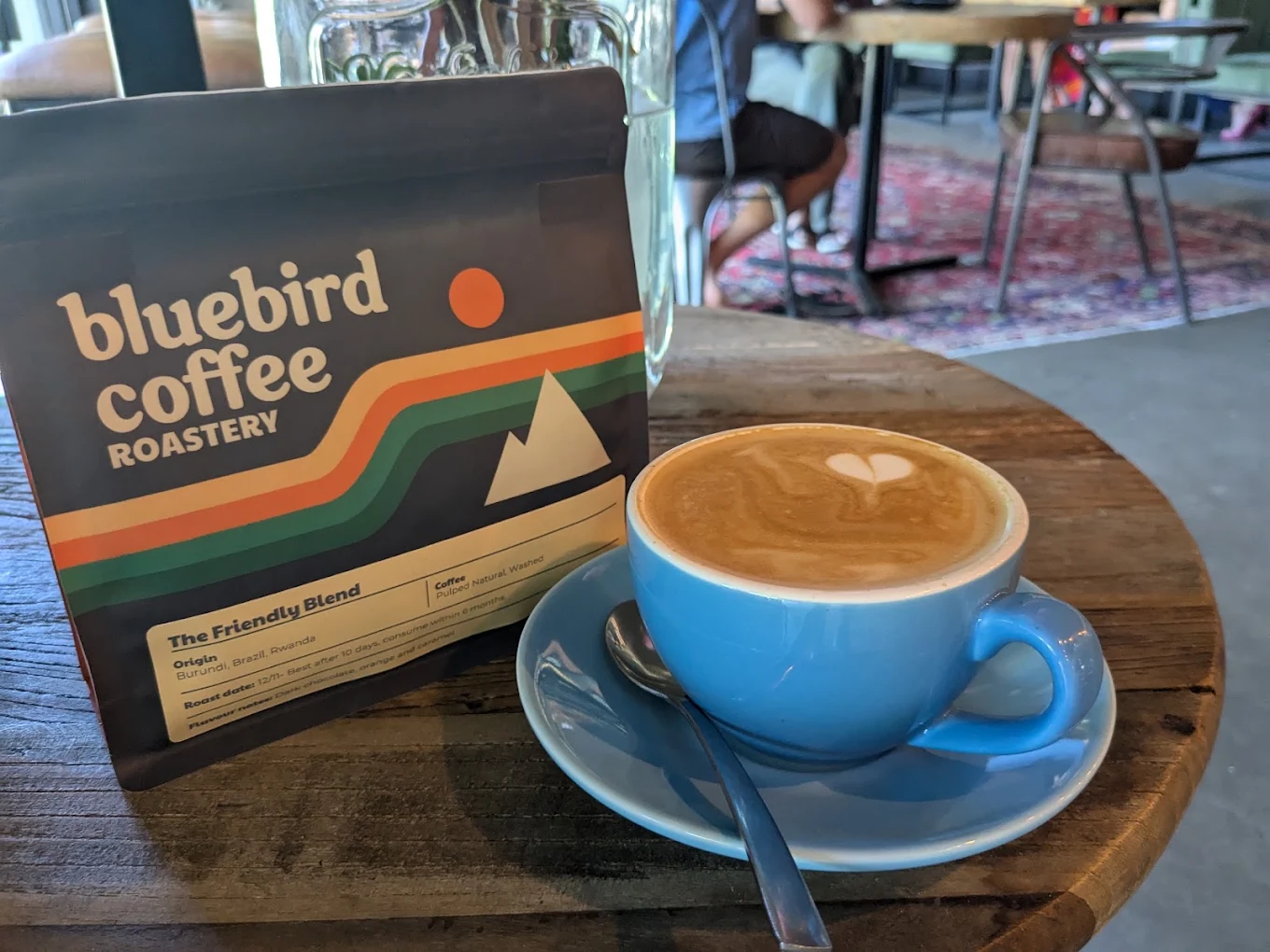 A cup of Coffee Craft coffee beside Bluebird Coffee Roastery Friendly Blend